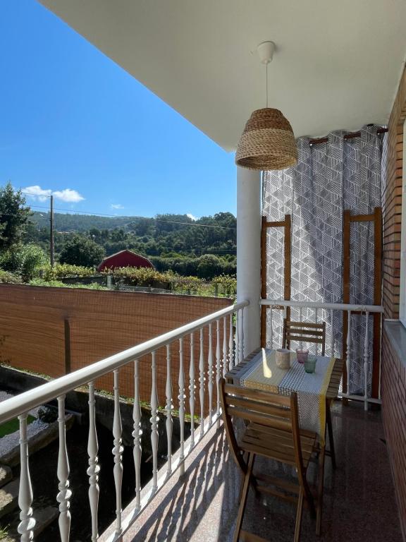 Zimmer mit einem Balkon mit einem Tisch und Aussicht in der Unterkunft Casa da Poza in Redondela