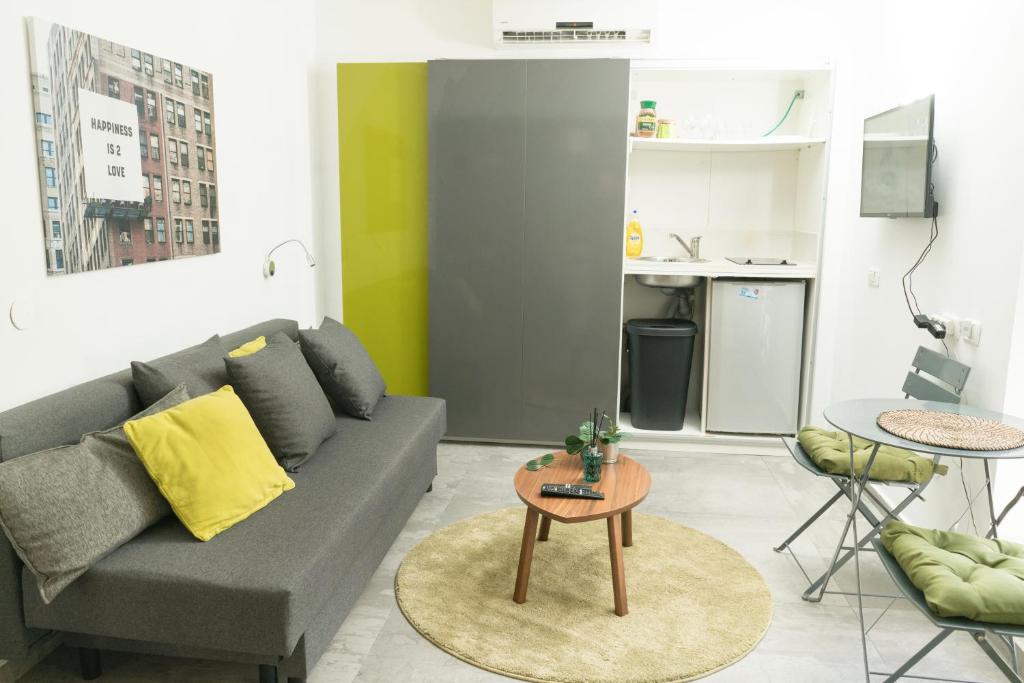 a living room with a couch and a table at Lily Studio Apart *Top location* in Jerusalem