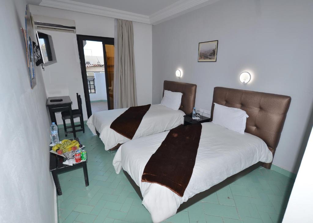Postel nebo postele na pokoji v ubytování Hotel Nouzha