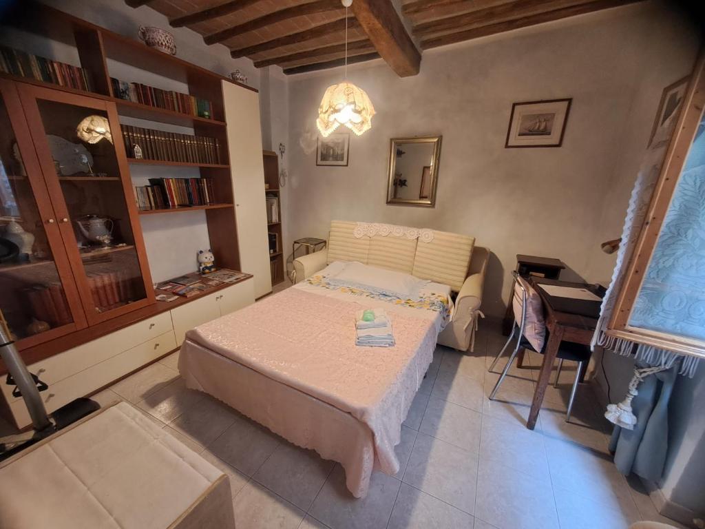 a bedroom with a bed and a table in it at La Bomboniera di Siena in Siena