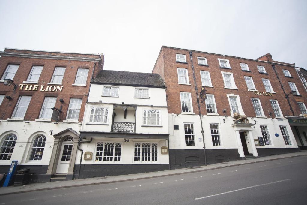 a row of buildings on a street next to a road at The Lion Hotel Shrewsbury in Shrewsbury