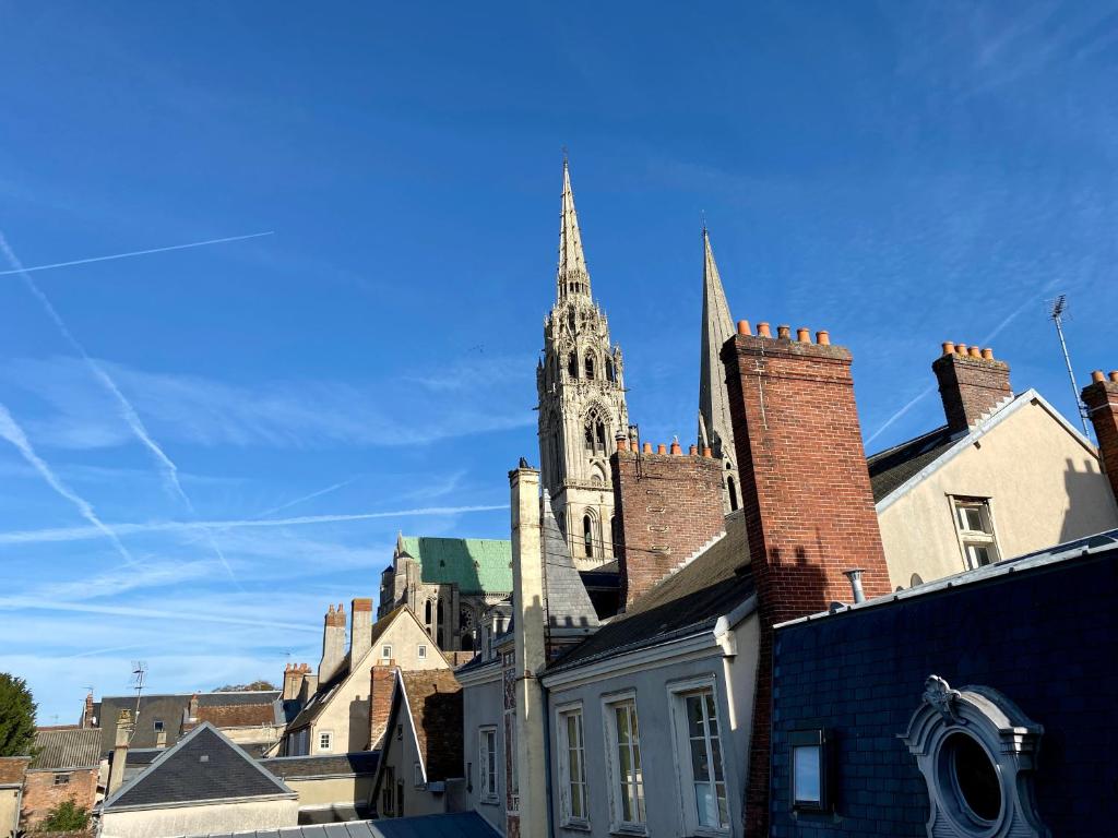 Hôtel Particulier de Champrond في شارتر: كنيسه ع برج الكنيسه فوق مدينه