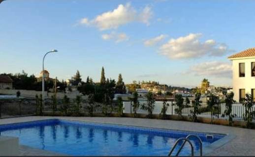 a large swimming pool in front of a building at Kosher Tersefanou Larnaca in Larnaca