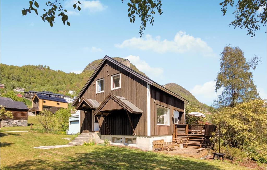 a large brown house with a hill in the background at Nice Home In Rldal With 4 Bedrooms in Røldal