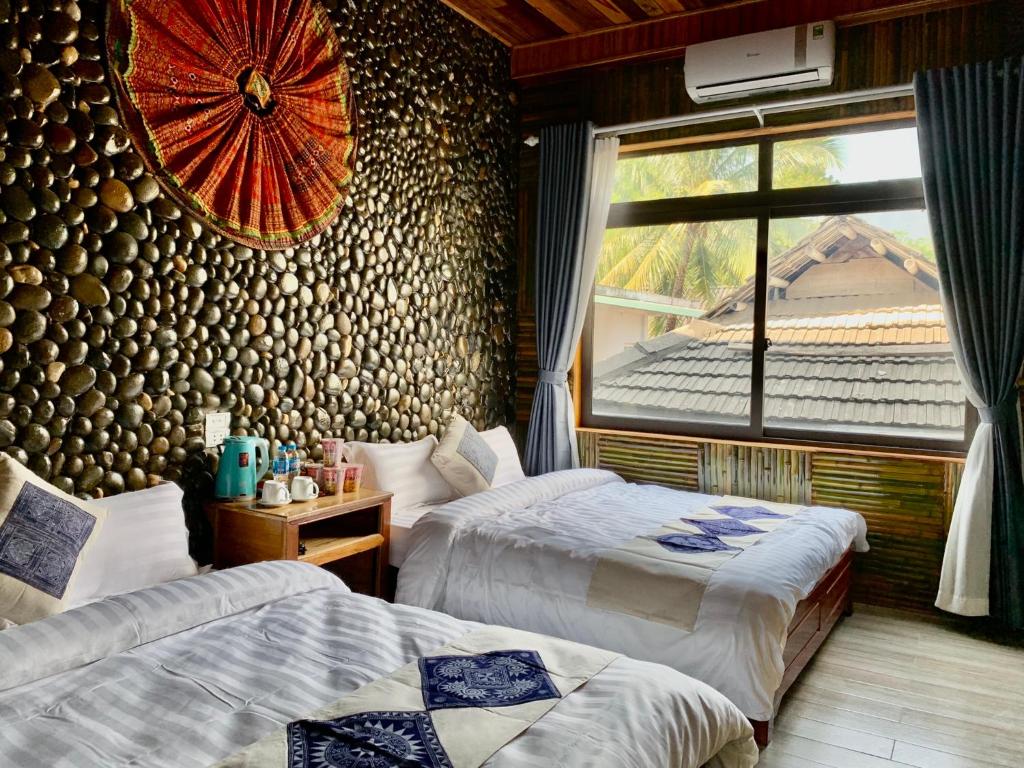 Postel nebo postele na pokoji v ubytování Mai Chau Moonlight Ecohouse