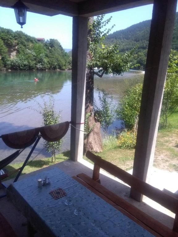 a view of a river from the porch of a house at Vikendica pored Drine Foča in Handići