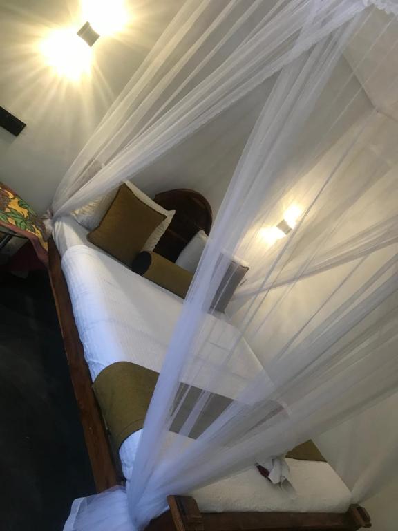Postel nebo postele na pokoji v ubytování Sapumal palace