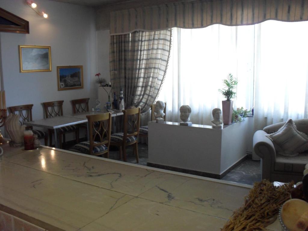 a living room filled with furniture and a large window at La Santre Villa in Amoudara Herakliou