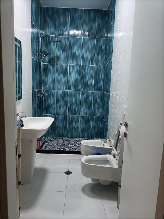 a bathroom with a sink and a toilet and a shower at Alvaros lake apartment in Sauk