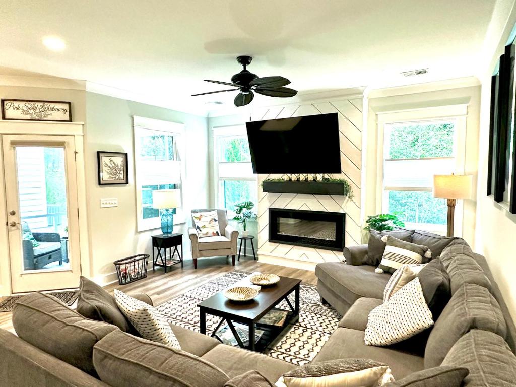 a living room with a couch and a fireplace at Pink Sand Hideaway in Hilton Head Island