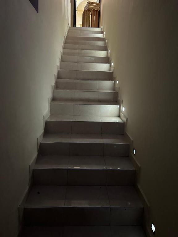 a stairway with a set of stairs with lights at Petite villa a hay dakhla in Agadir