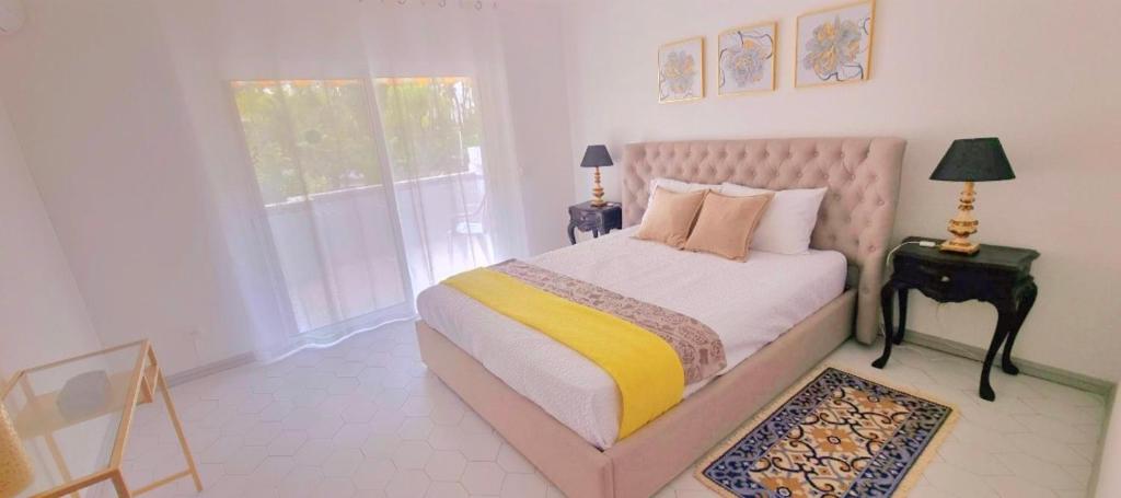 a bedroom with a pink bed and a window at Seaside SunFlower in Quinta do Lago