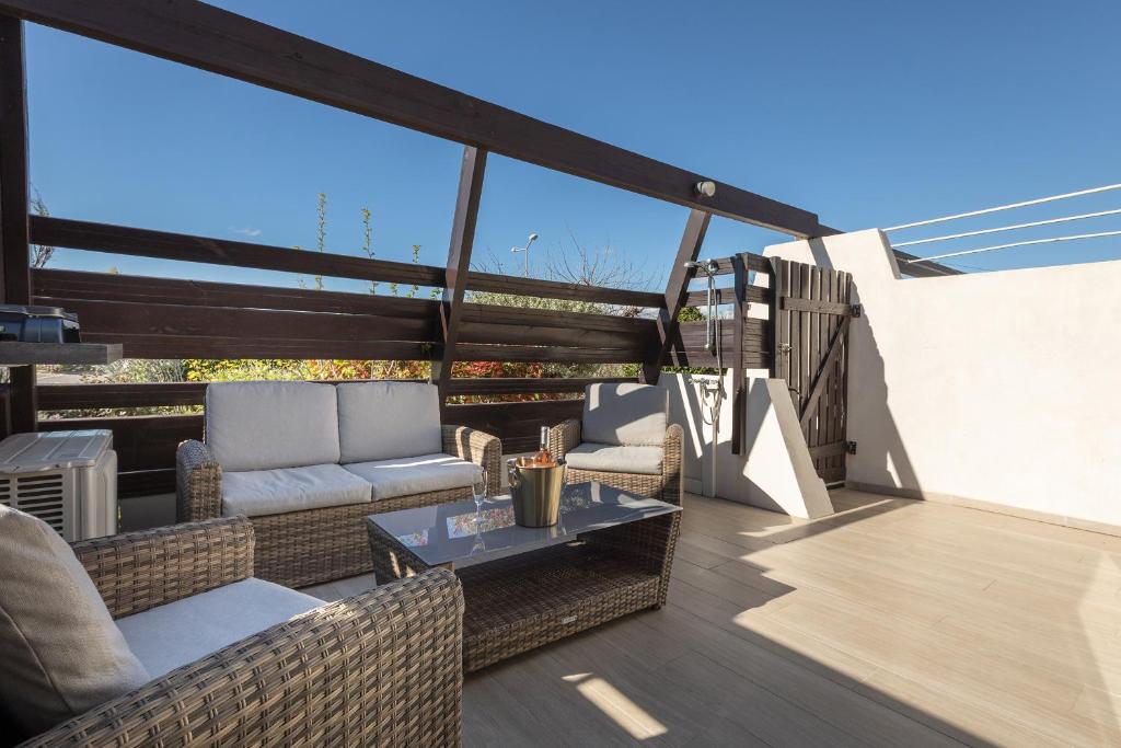 a patio with couches and a table on a balcony at Golden Paradise Port nature village in Cap d'Agde