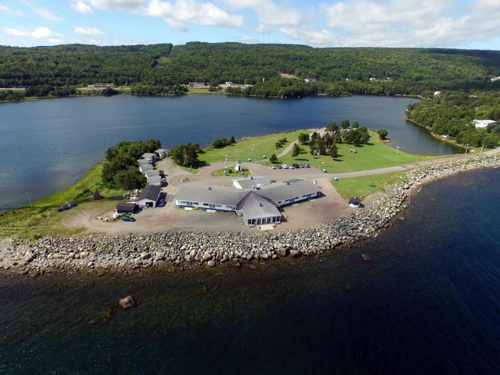 an aerial view of a house on an island in the water at The Cove Motel & Restaurant in Aulds Cove