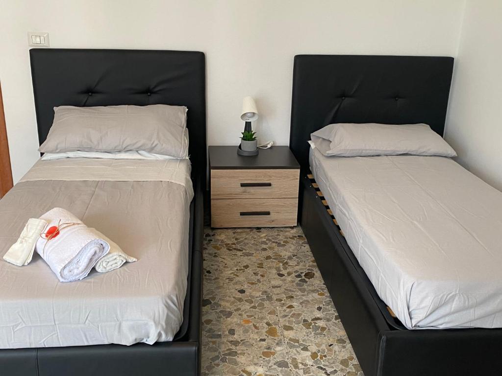 two beds sitting next to each other in a bedroom at Pisana 247 St Peter in Rome