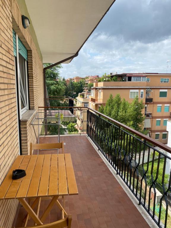 a balcony with a wooden bench and a table at Pisana 247 St Peter in Rome