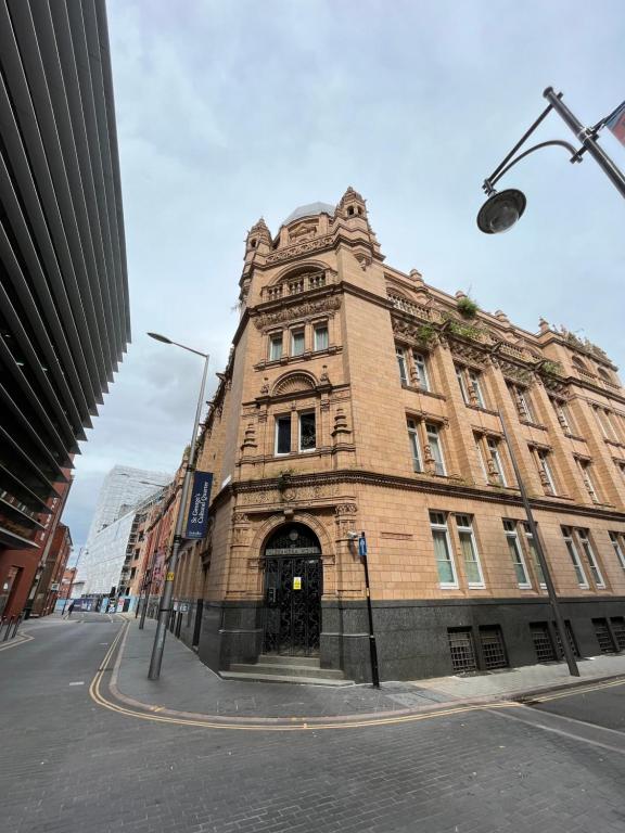 a large brick building on the corner of a street at Ensuite Private Room in Central Stylish Flat in Leicester