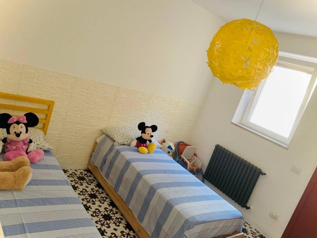 Łóżko lub łóżka w pokoju w obiekcie Residenza Gli Oleandri