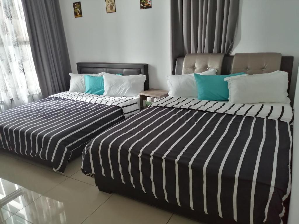 Un pat sau paturi într-o cameră la Melaka Carol Leisure Stay