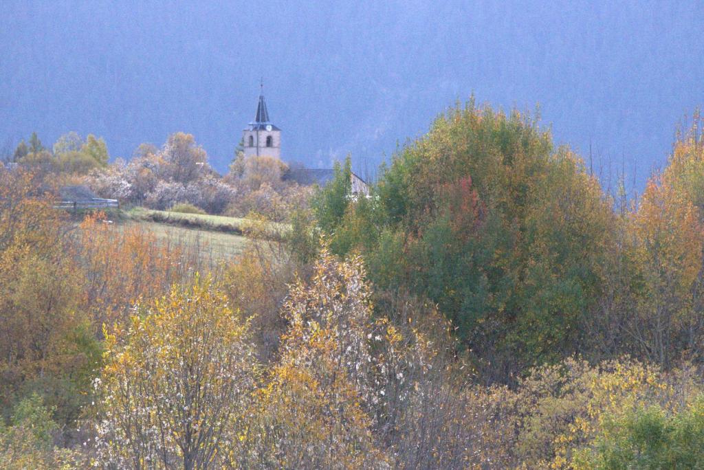 a building on top of a hill with trees at Les Marmottes 18 C in La Chal