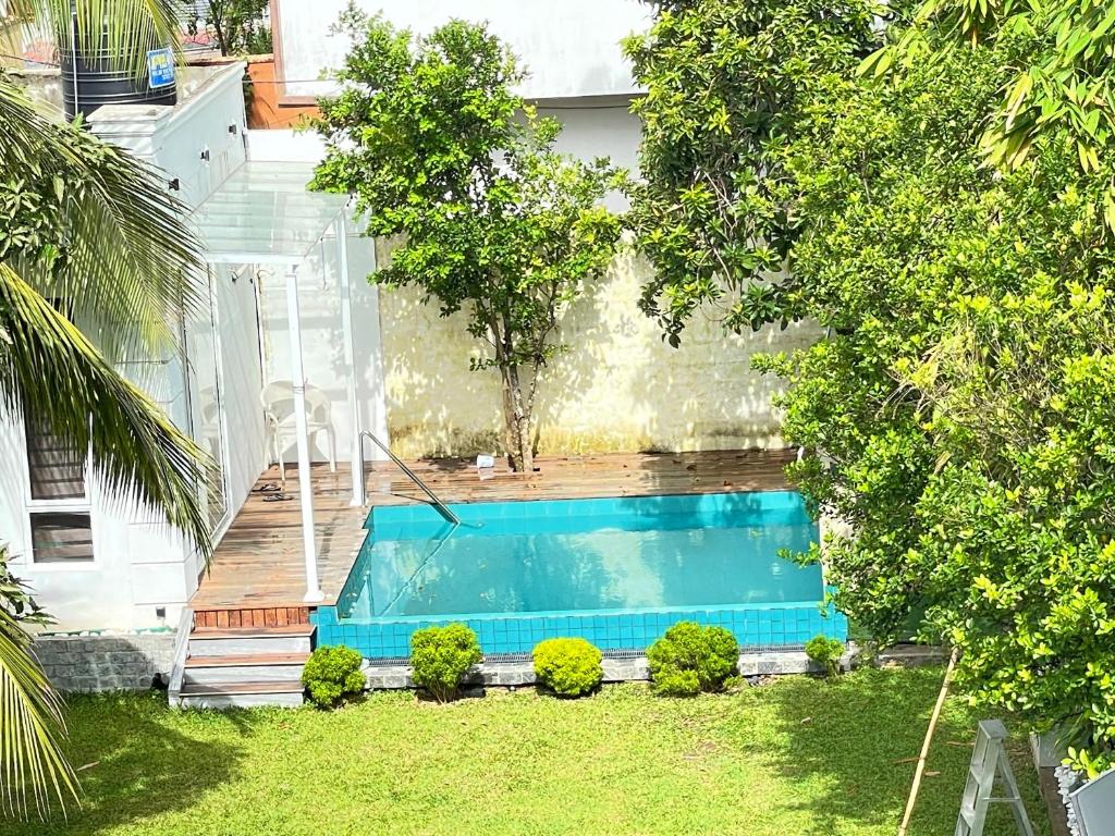 a swimming pool in the backyard of a house at Villa with a private pool and Garden-Ivory Villa Not for Local in Kandana