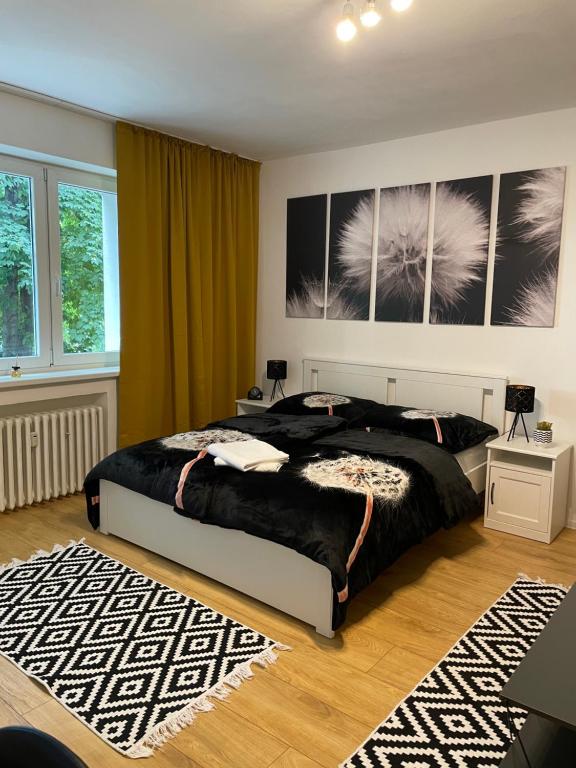 a bedroom with a large bed and a rug at Studio Apartment Dandelion in Bratislava