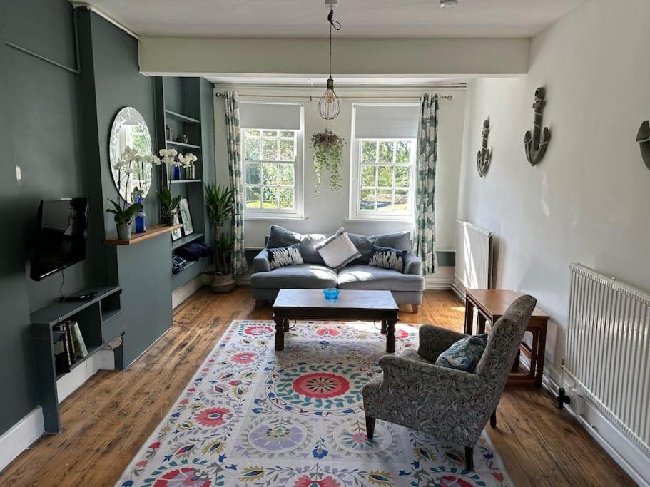 a living room with a couch and a table at Unique English Heritage Escape in *Bembridge* IOW in Bembridge