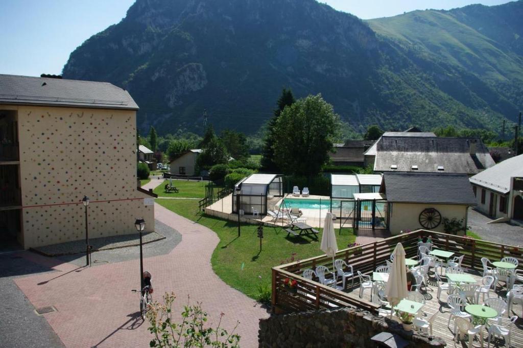 - une vue sur un complexe avec une piscine et une montagne dans l'établissement Appartement avec piscine en Vallée d’Ossau, à Bielle