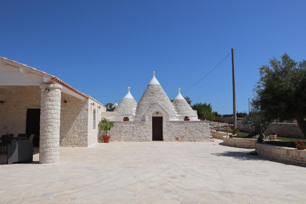a white building with turrets on the side of it at Dimora Sasa in Putignano