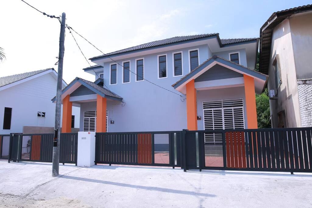 a white house with a black fence at Green Dream Homestay 3 Kota Bharu 3 Aircond Room With Wifi & Netflix in Kota Bharu