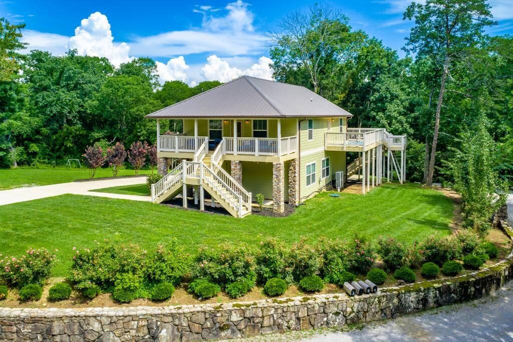 a large yellow house with a stone wall at Lookout Escape - Top of Lookout Mountain in Lookout Mountain