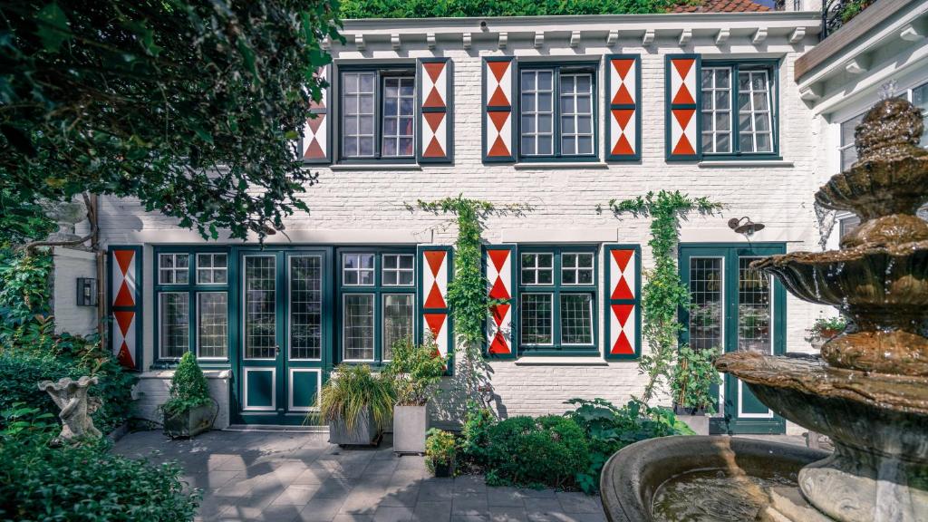 a building with red white and blue flags on it at B&B Barabas in Bruges