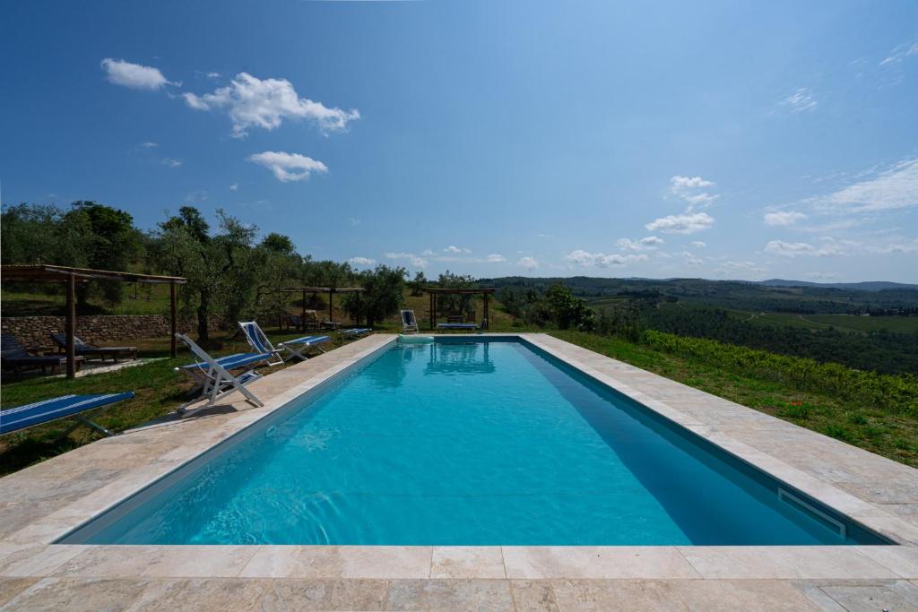 a swimming pool with a view of the mountains at Casa ALTA in Greve in Chianti