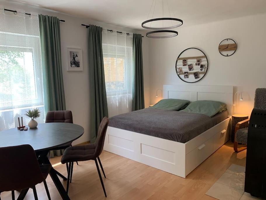 a bedroom with a bed and a table and chairs at A Vidám Vándor Vendégház in Zalaszántó