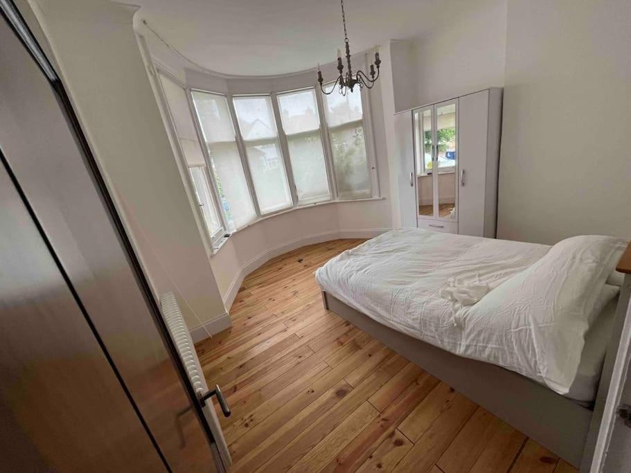 a bedroom with a bed and a large window at One Bed Flat With Garden in London
