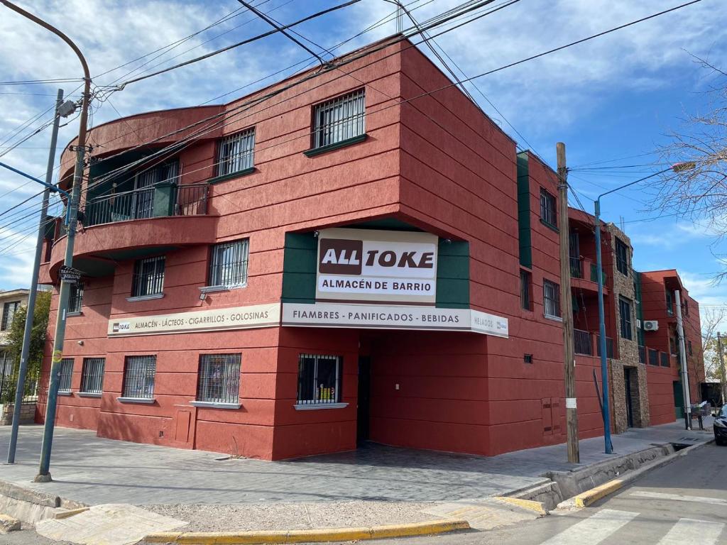 a red building with an all node insurance building at Elegante departamento en Mendoza in Mendoza