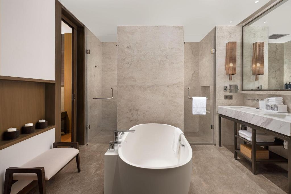 a bathroom with a tub and a sink at Sheraton Cebu Mactan Resort in Mactan