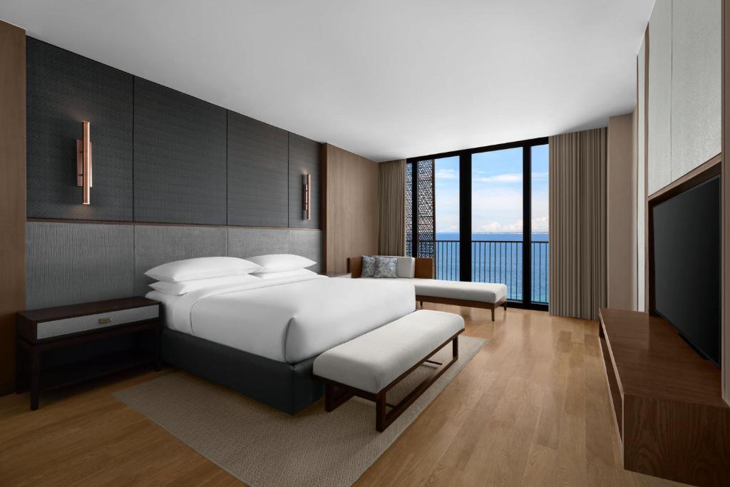 a bedroom with a bed and a flat screen tv at Sheraton Cebu Mactan Resort in Mactan