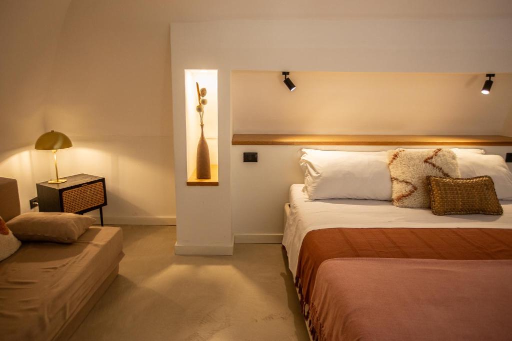 ein Schlafzimmer mit einem Bett und einem Sofa in einem Zimmer in der Unterkunft ES Suites in Neapel