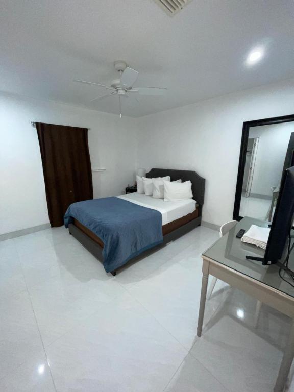 a bedroom with a bed and a desk and a television at bedroom with sharing bathroom in Boca Raton