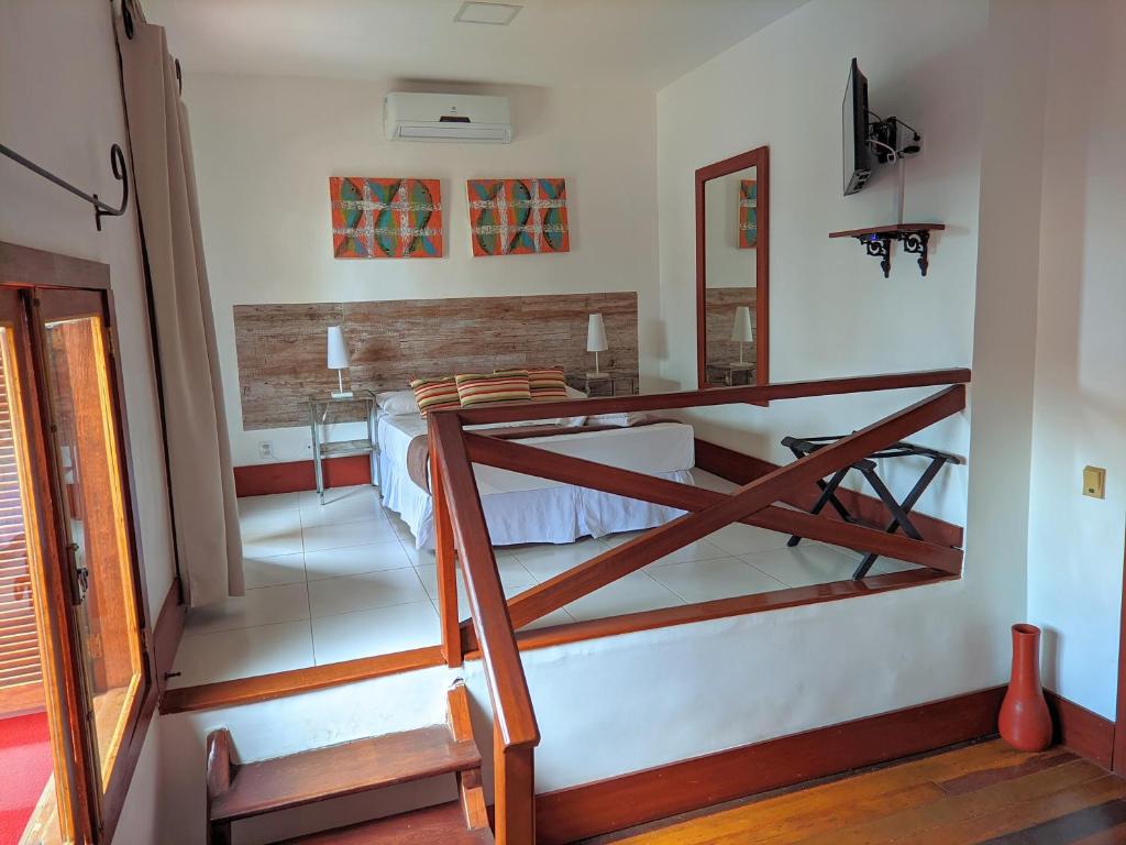 a bedroom with a bunk bed in a room at Pousada Villegaignon in Búzios
