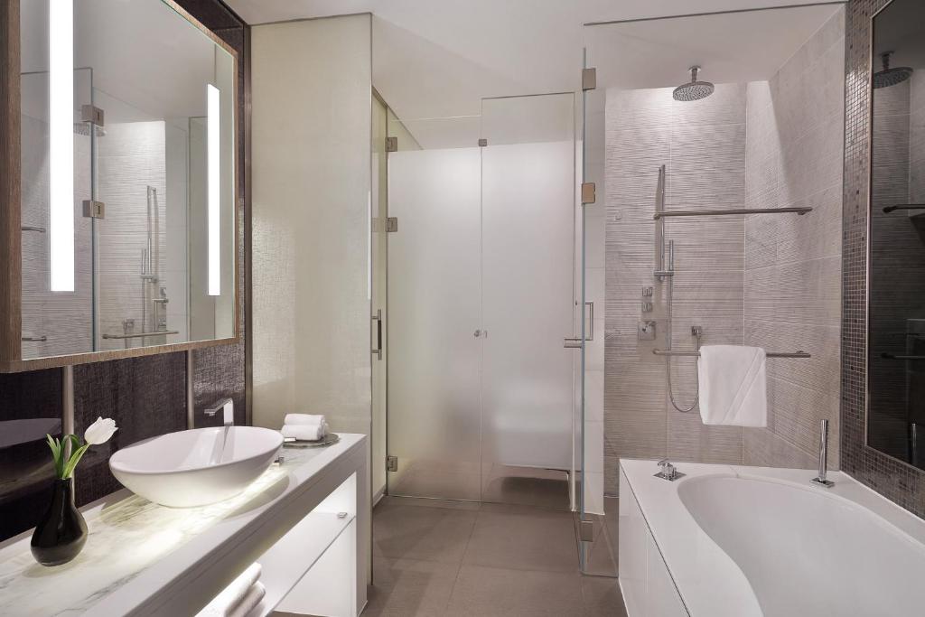 a bathroom with a tub and a sink and a shower at W Abu Dhabi - Yas Island in Abu Dhabi