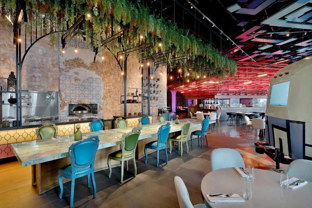 a dining room with a long table and chairs at W Abu Dhabi - Yas Island in Abu Dhabi