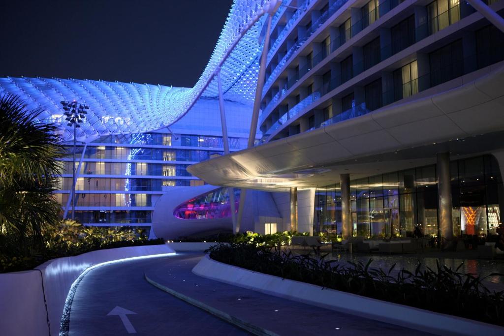 a building with blue lights on it at night at W Abu Dhabi - Yas Island in Abu Dhabi
