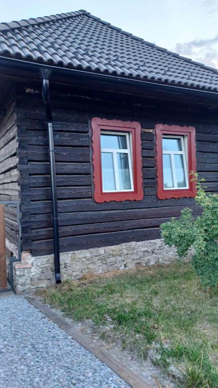 a log cabin with two windows on the side of it at DREVENICA in Hrabušice