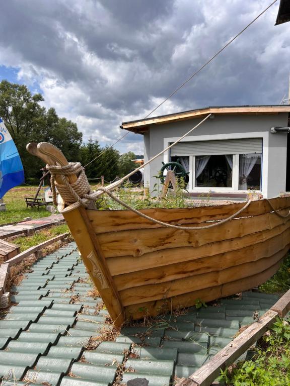 a wooden boat sitting on top of a stone floor at Marina Arka Noego in Krzeszów