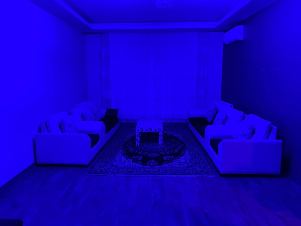 a living room with two couches and a blue light at Apartment in Buyukcekmece