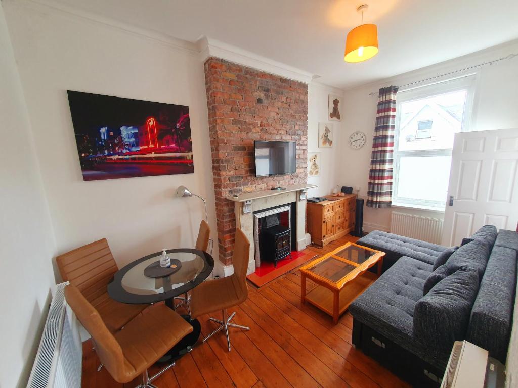 a living room with a couch and a table at F3 2 BEDROOMED TOWN HOUSE - FREE Parking - Super 150 Mbps WiFi Near Gavin n Stacey Film House - 1 FREE DOG ALLOWED in Barry