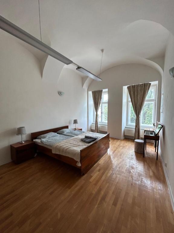 a large bedroom with a large bed and wooden floors at BEST VIEW in the Heart of Kosice in Košice