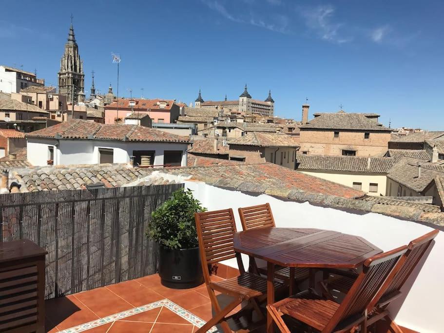 a table and chairs on a balcony with a view at 15th Century Palace with Beautiful Private Terrace in Toledo